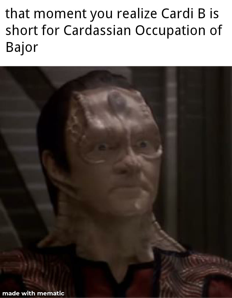 This meme features a still image from the TV show Star Trek: Deep Space Nine, specifically a character named Dax, who is a shape-shifting alien. The text above the image reads "I'm not saying Cardi B is a Klingon... but" and the text below the image says "I'm not saying Cardi B is a Klingon... but... I'm not saying Cardi B is a Klingon...". The meme is playing on the idea that Cardi B, an American rapper, is not a Klingon, which is a reference to the Klingon Empire from the Star Trek franchise.